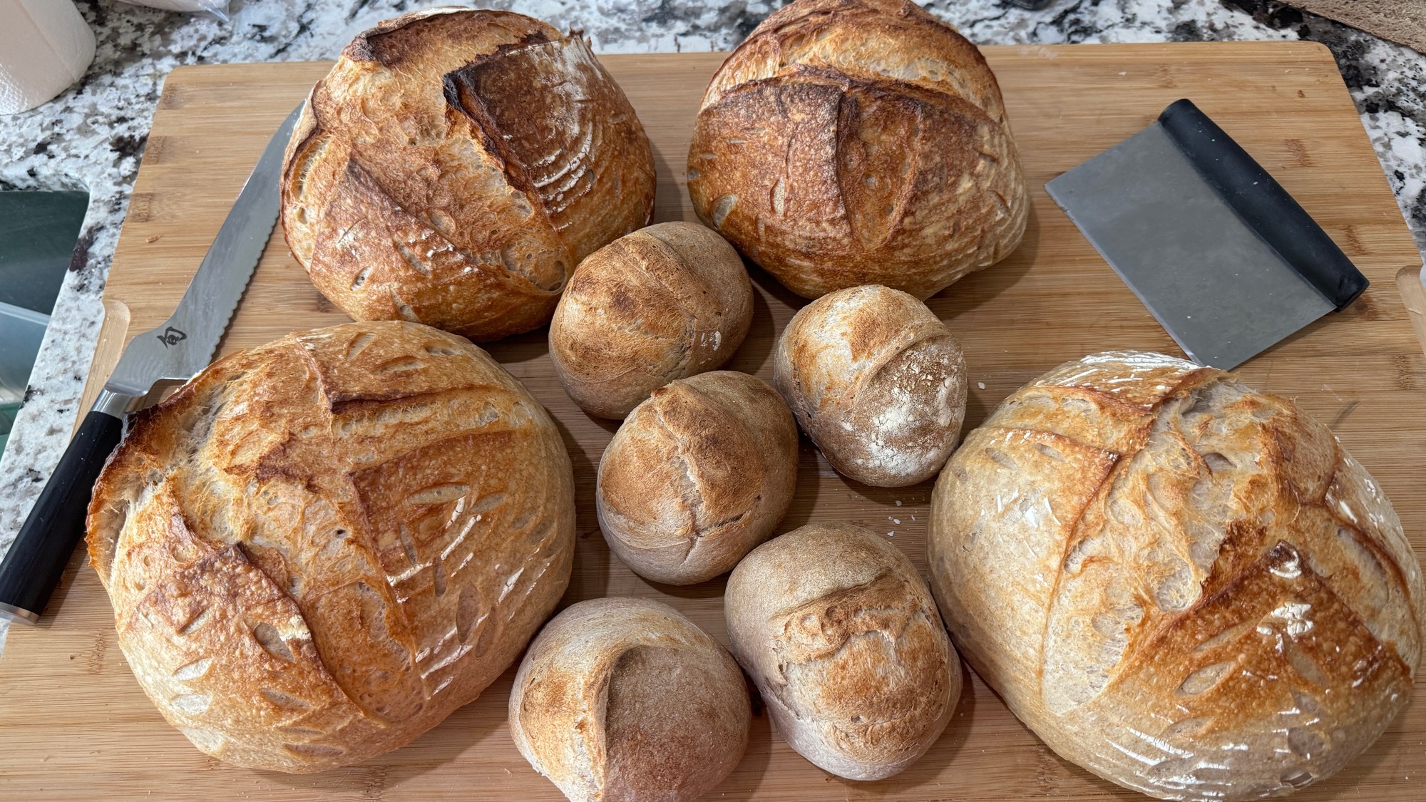Brett’s round loaves and smaller rolls arranged on a wooden board